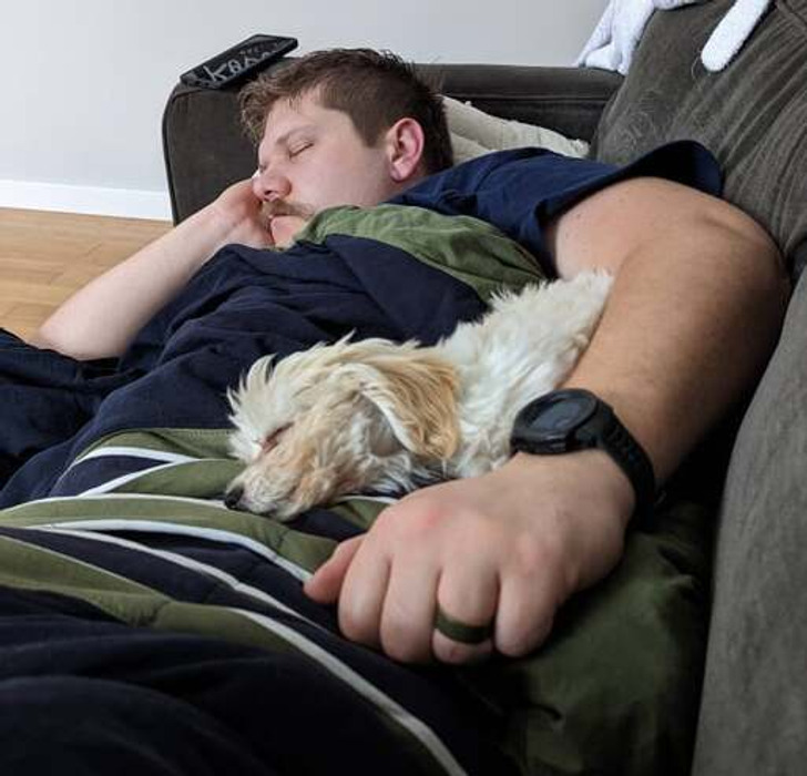 This image has an empty alt attribute; its file name is dog-owner-sleeping.jpg